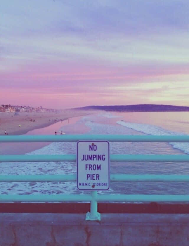 A Sign That Says No Jumping Off The Pier Wallpaper