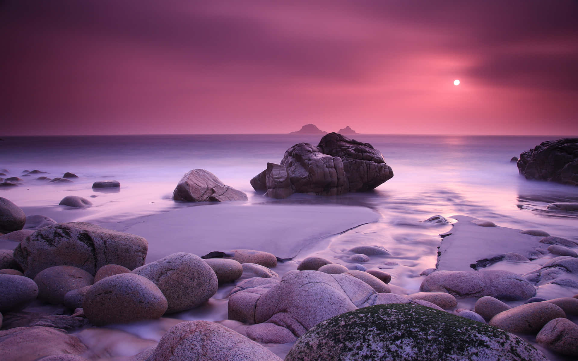 "A beautiful pink sky illuminated the shore of this beach during sunset." Wallpaper