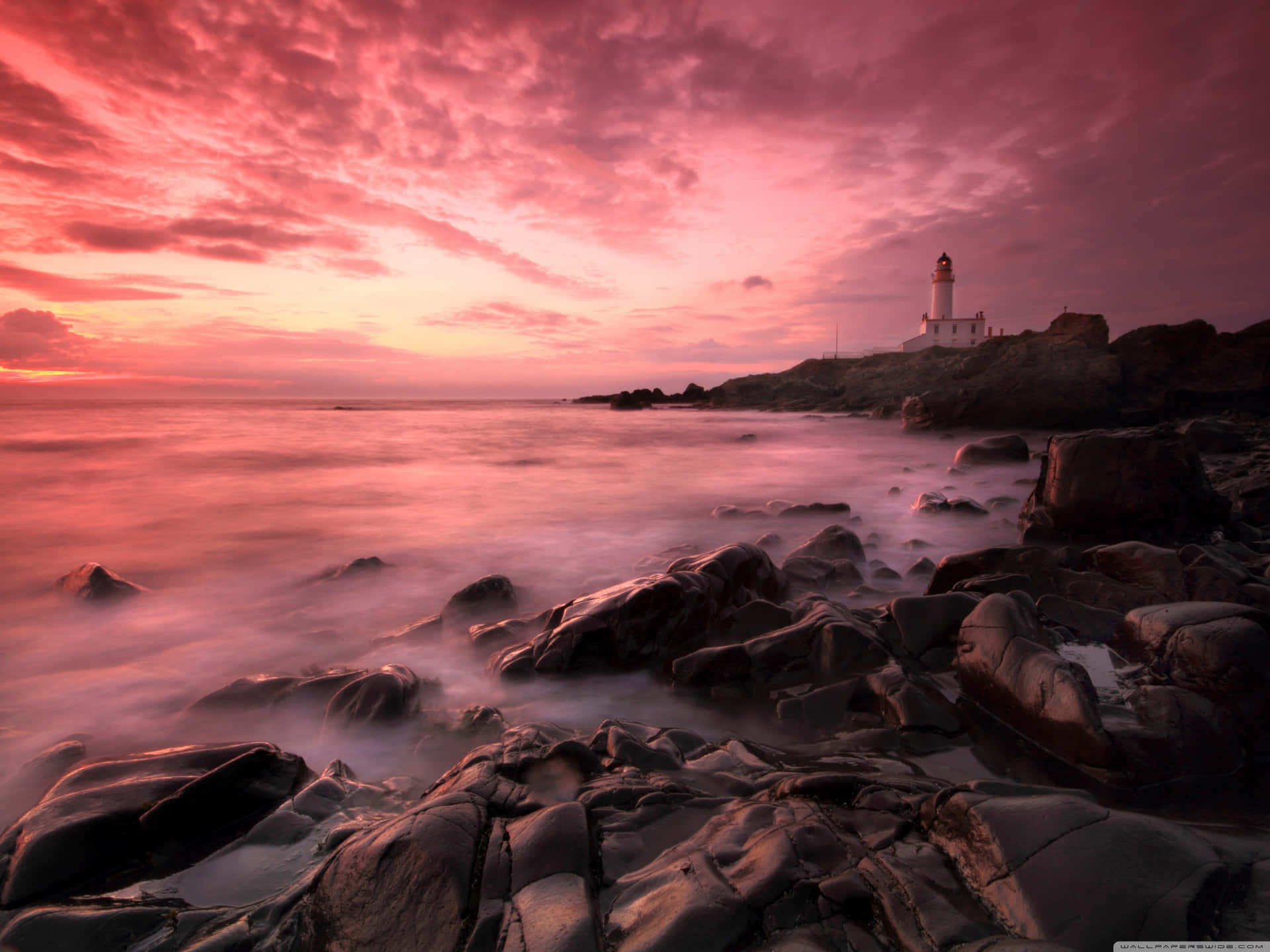"Beautiful pink hues take over the sky at sunset, painting the landscape of the beach." Wallpaper