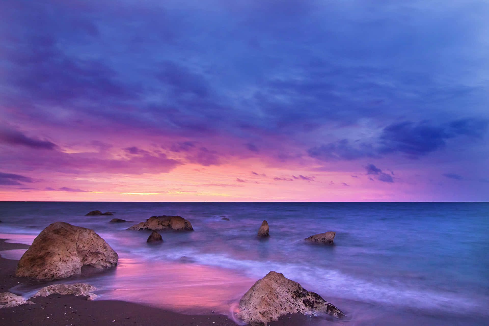 Pink Beach Sunset With Purple Waters Wallpaper