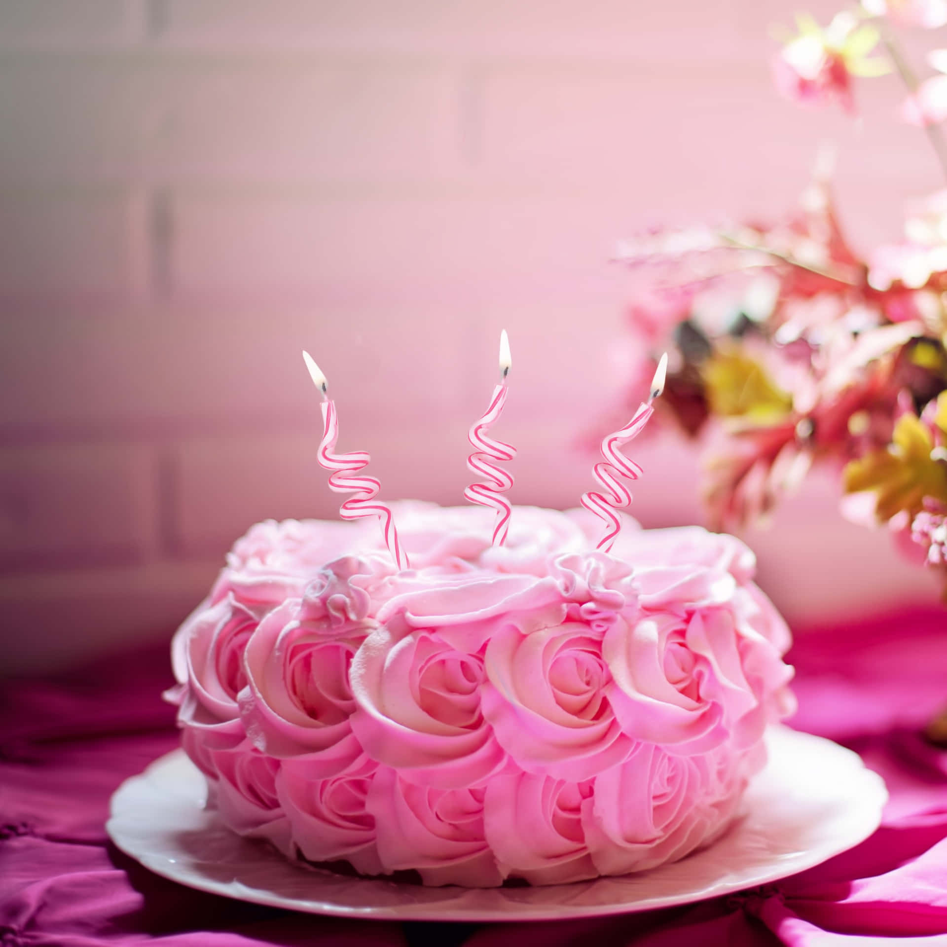 A Pink Cake With Candles On Top Wallpaper