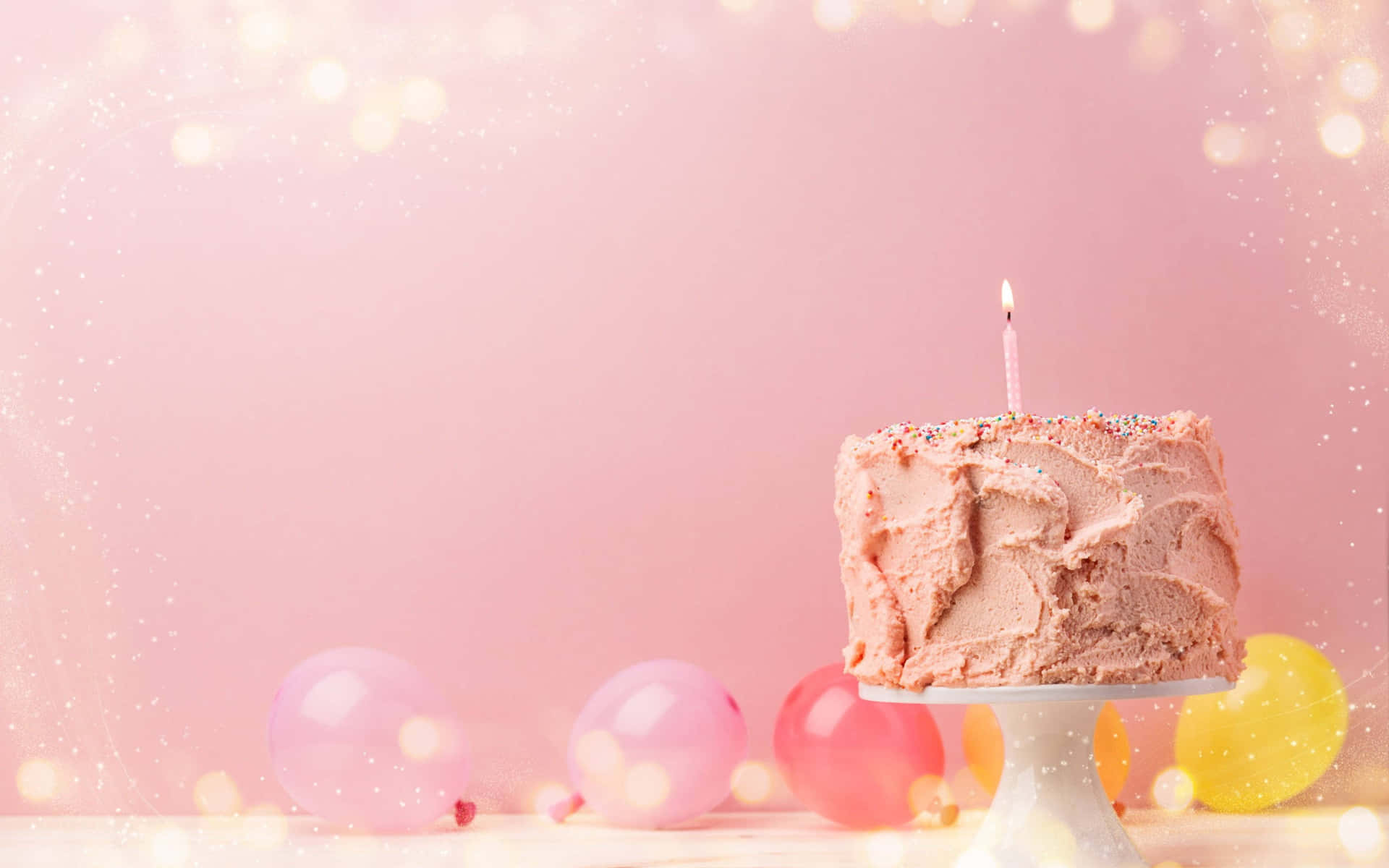 A Pink Cake On A White Plate With Balloons On A Pink Background Wallpaper