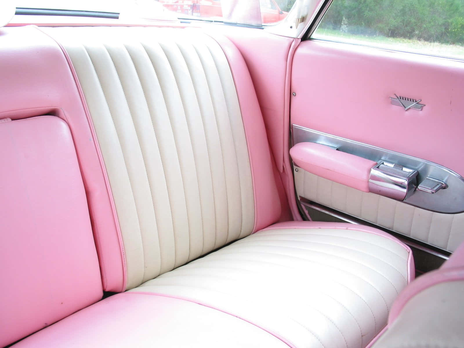 Classic Pink Cadillac in an urban setting Wallpaper