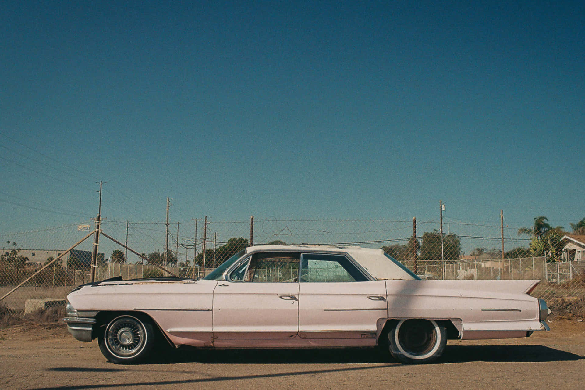 Vintage Pink Cadillac on the Open Road Wallpaper