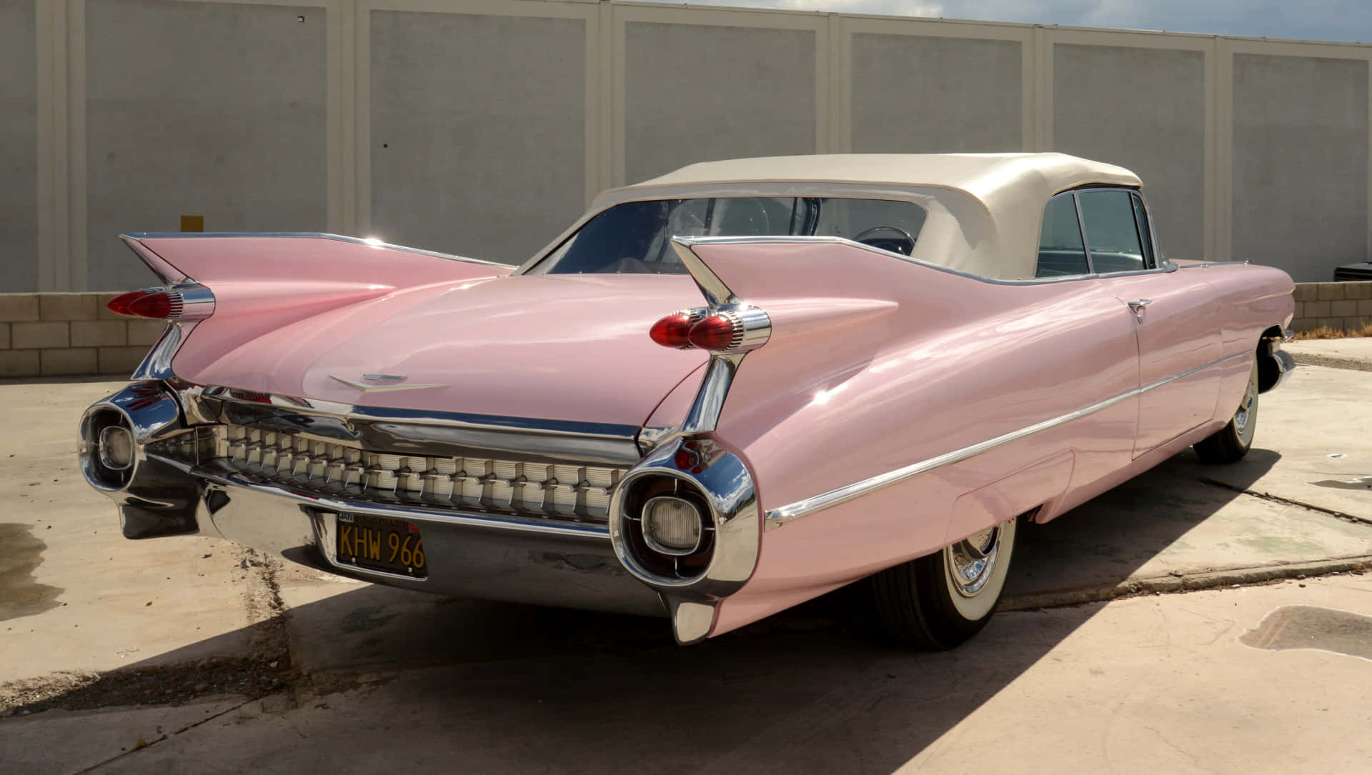 Classic Pink Cadillac on an open road Wallpaper