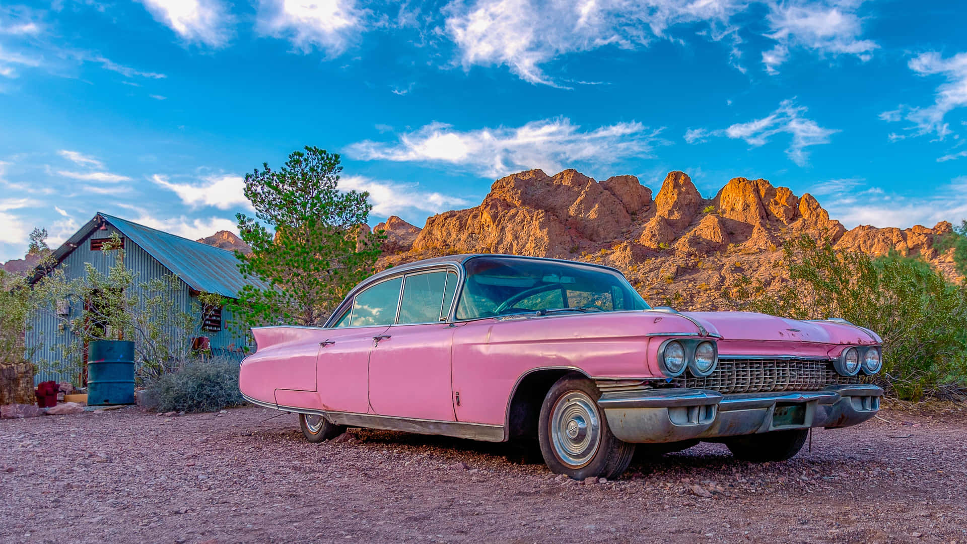 Stylish Pink Cadillac on Urban Street Wallpaper