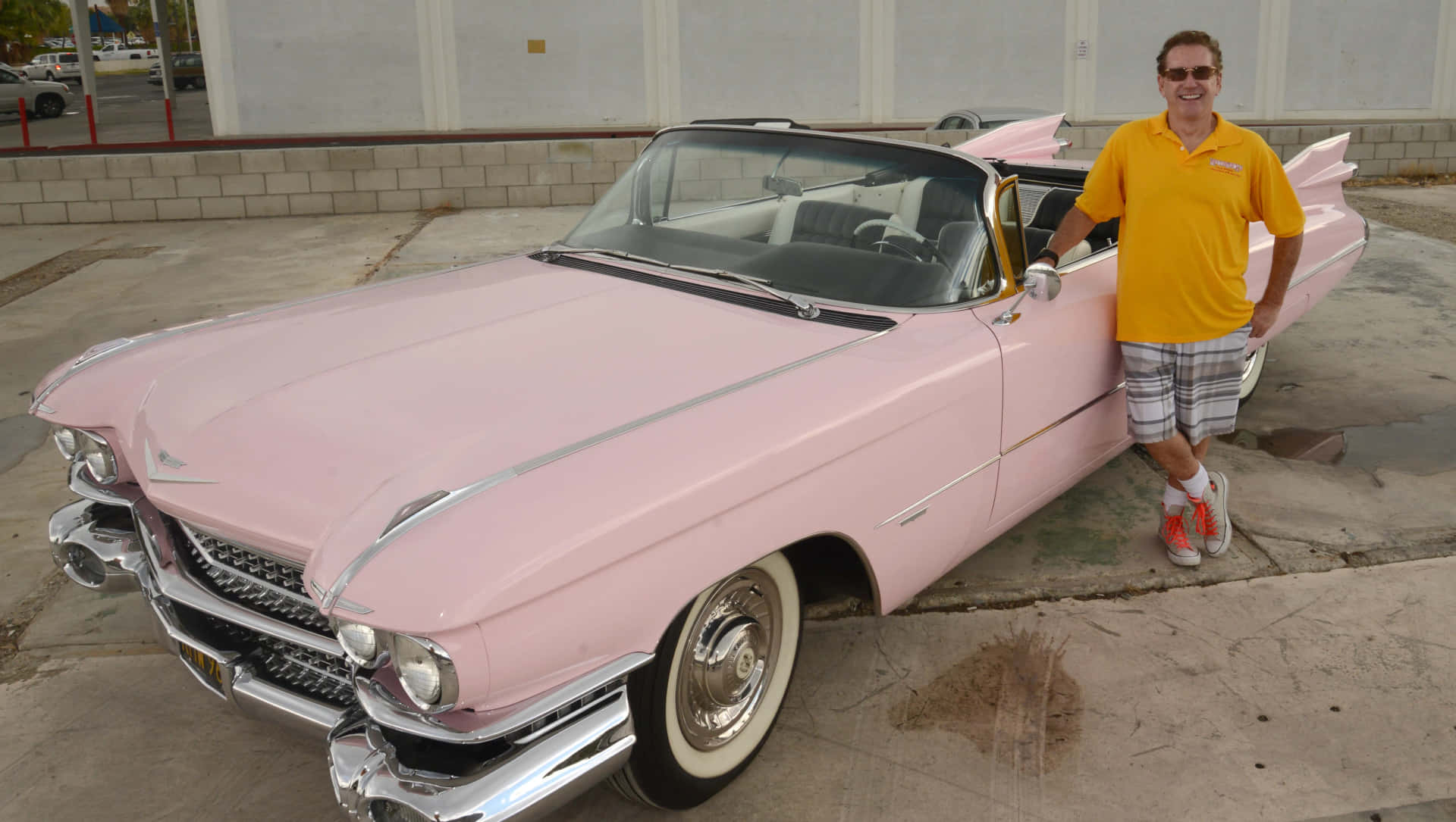 Classic Pink Cadillac in a picturesque setting Wallpaper