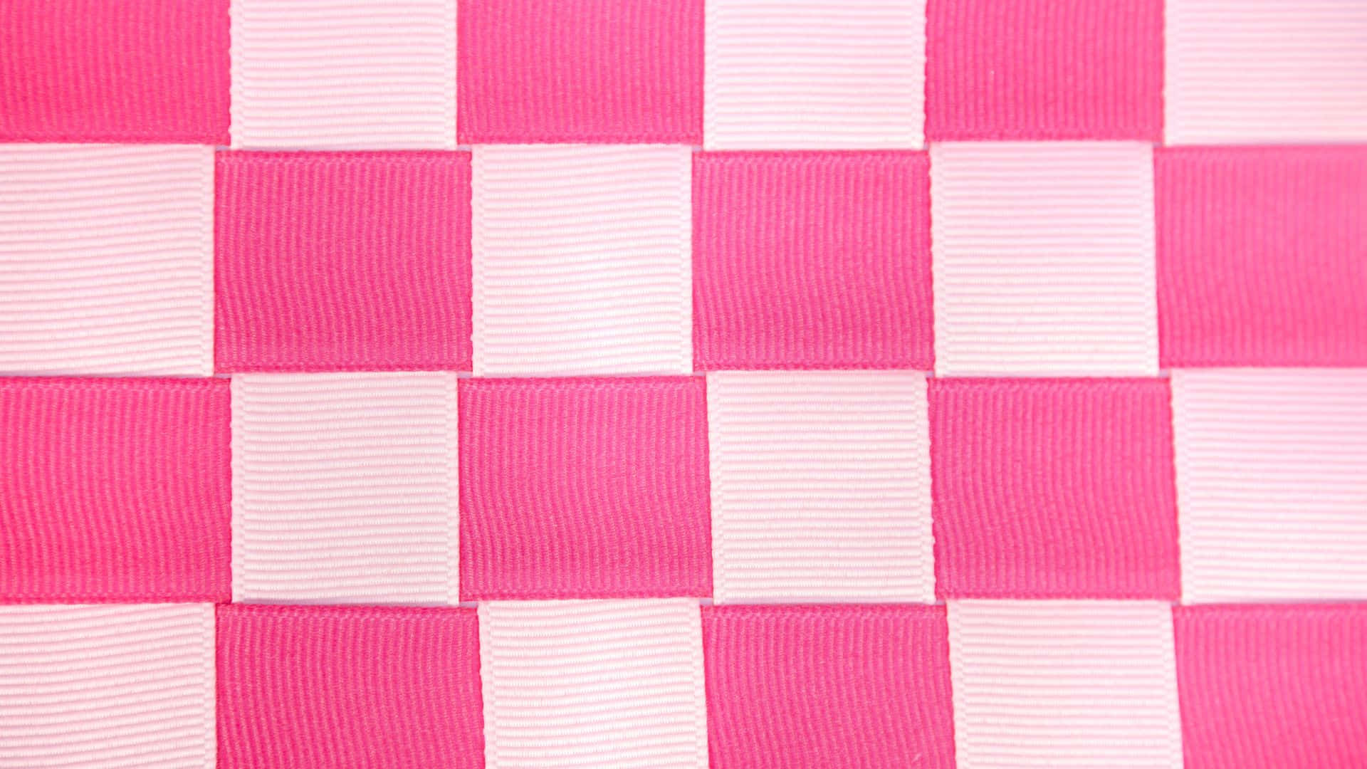 A vibrant pink checkered pattern fills the entire frame. Wallpaper
