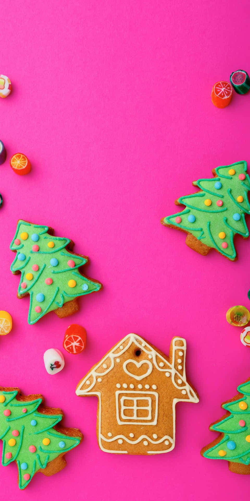 Gingerbread Cookies And Candies On A Pink Background