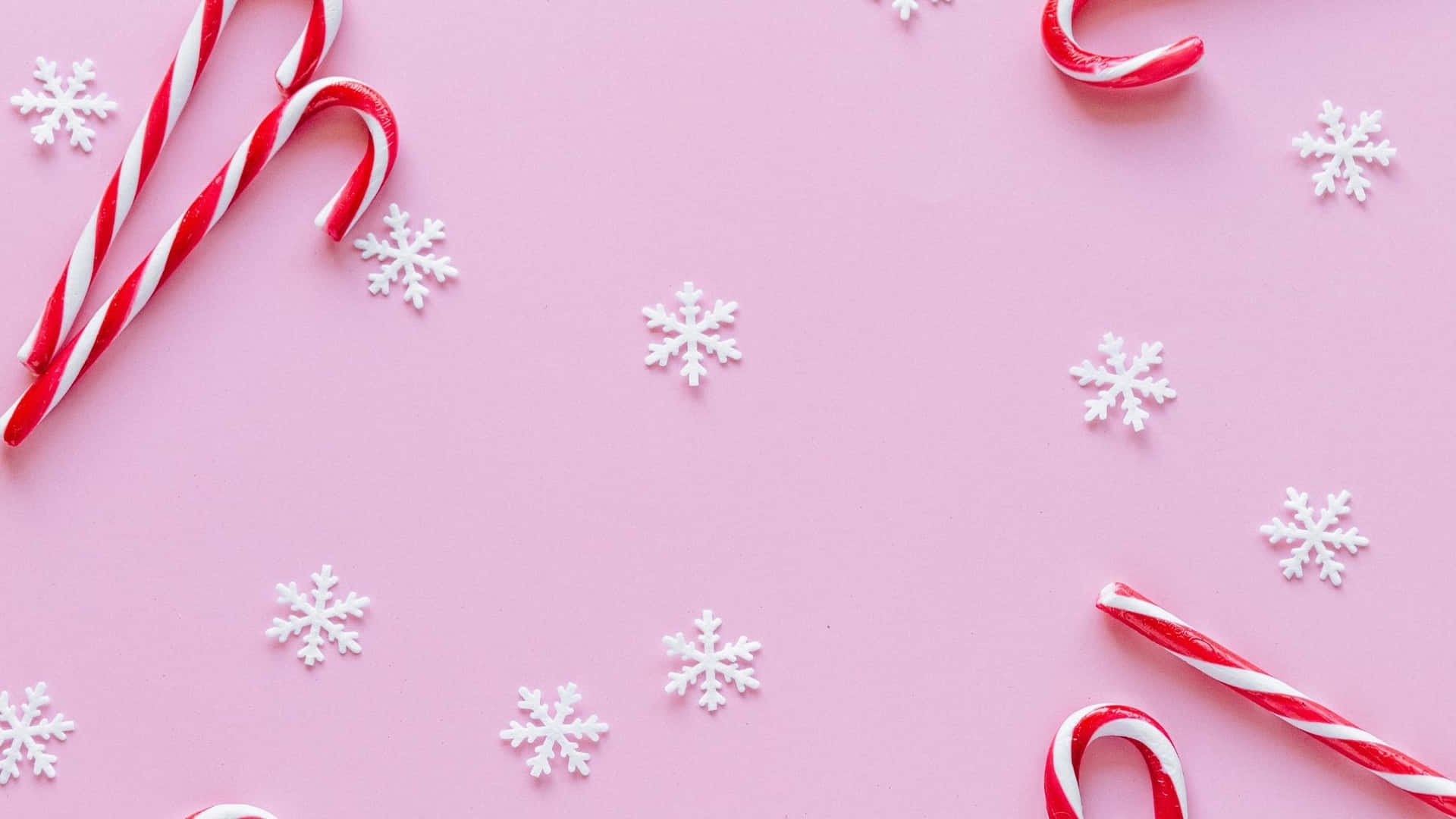 Candy Canes And Snowflakes On A Pink Background