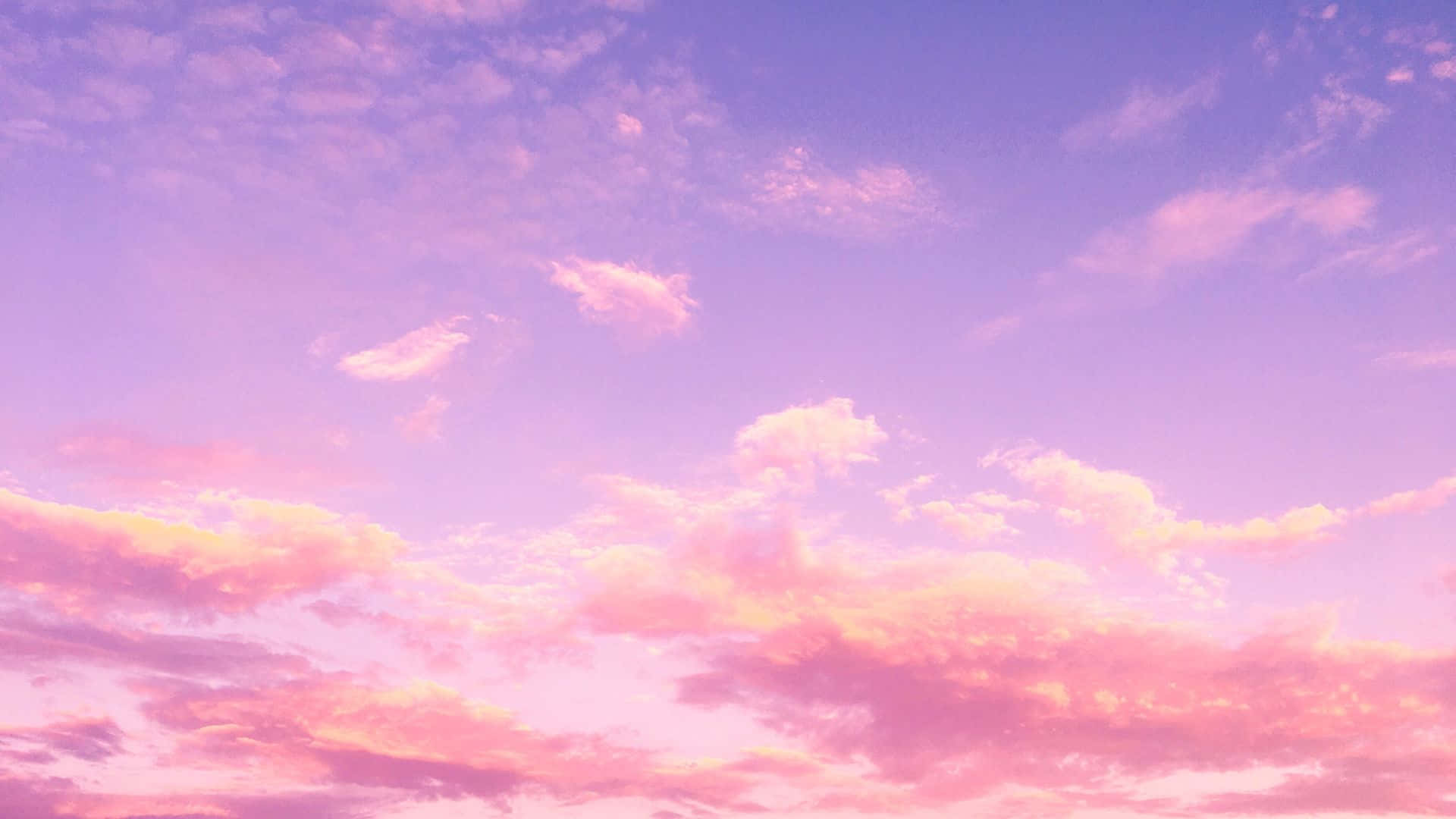 a pink sky with clouds in the background