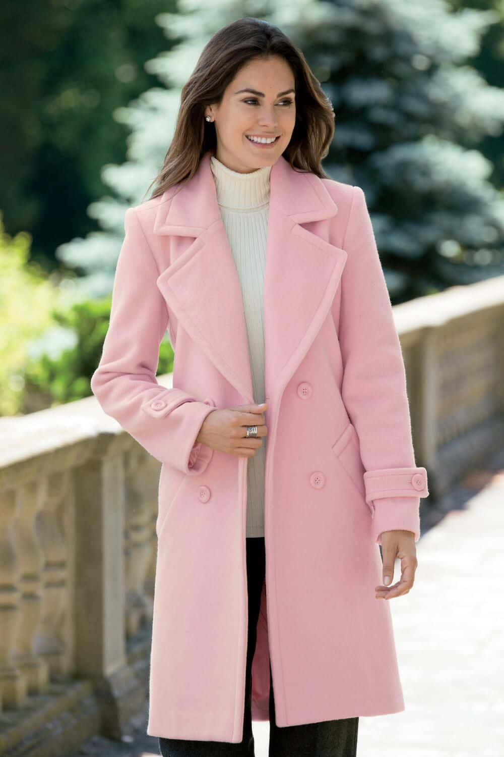 Chic young woman in a stylish pink coat Wallpaper