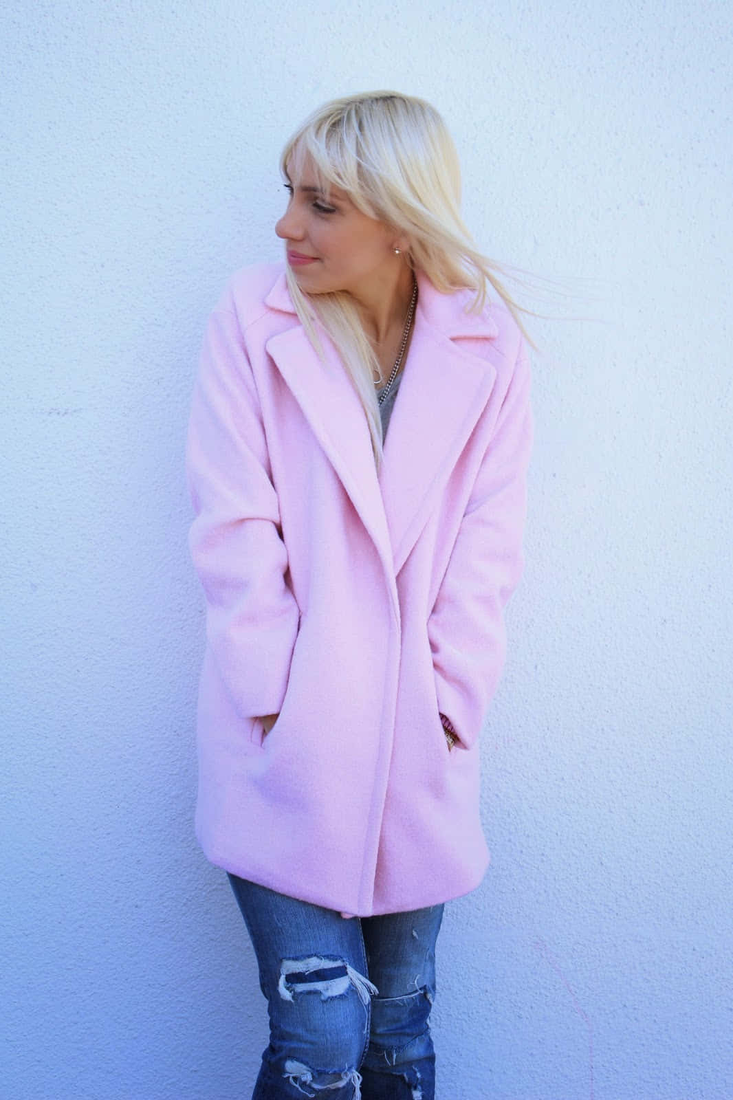 Stylish woman in elegant pink coat Wallpaper