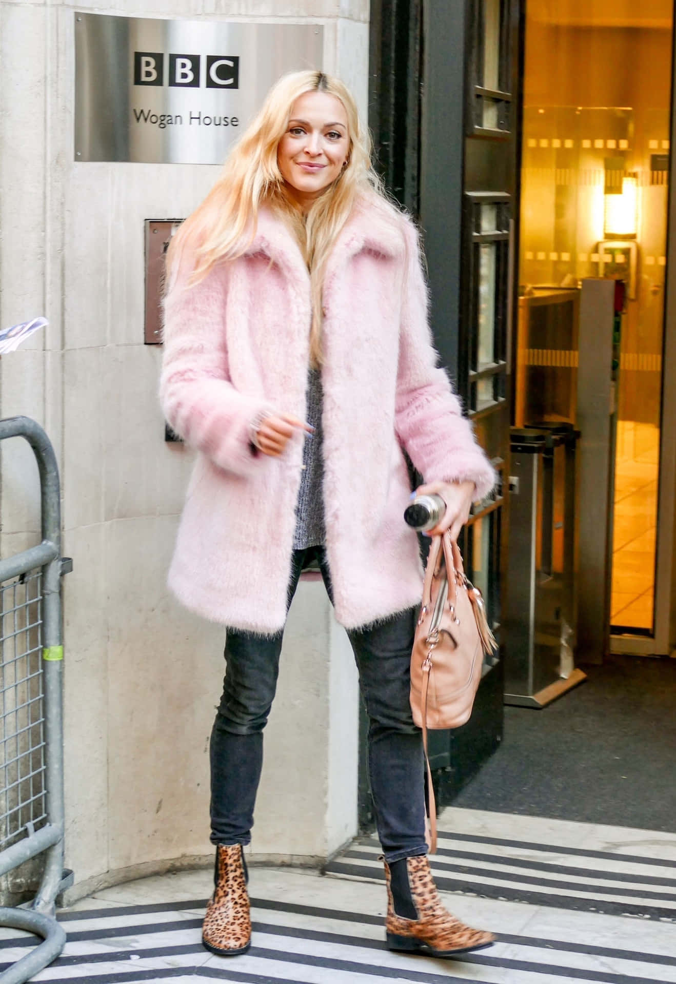 Stylish Woman in Chic Pink Coat Wallpaper