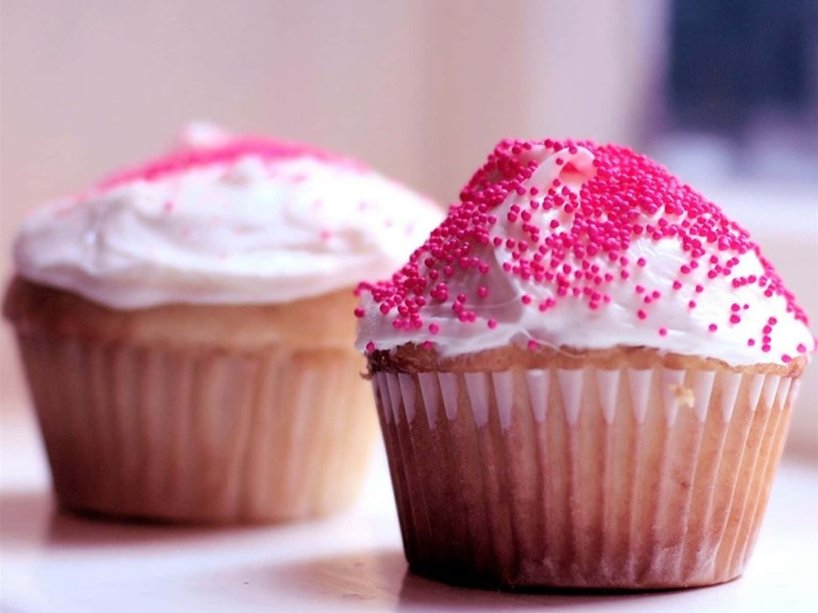 Delectable Pink Cupcakes on Display Wallpaper