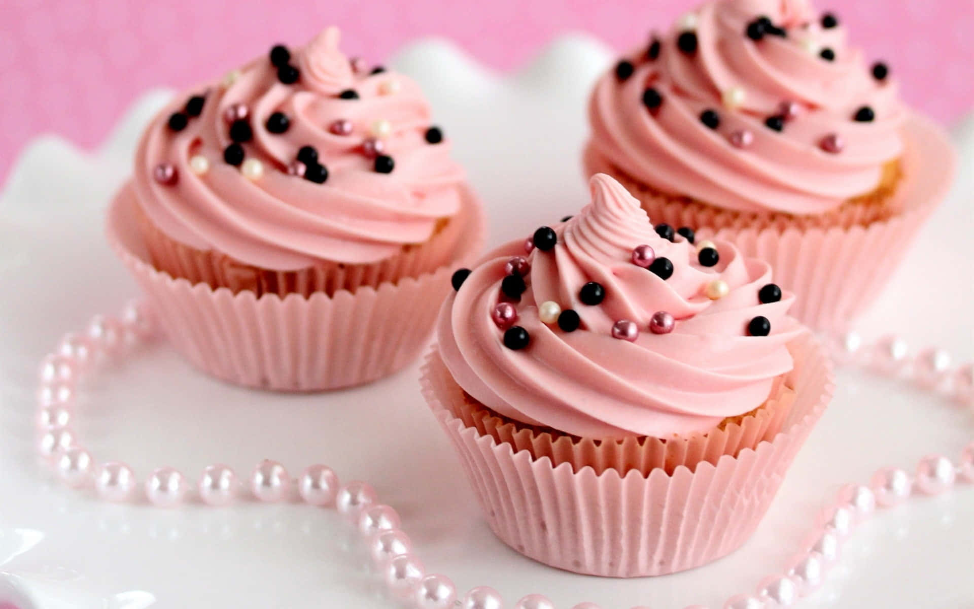 Scrumptious Pink Cupcakes on Display Wallpaper
