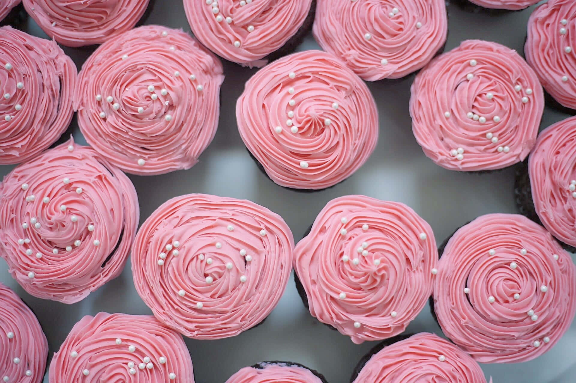 Delectable Pink Cupcakes with Colorful Sprinkles Wallpaper