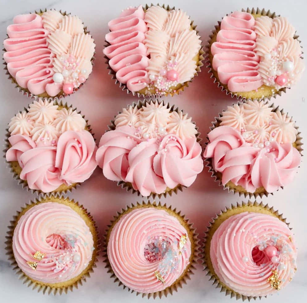 Delicious Pink Cupcakes on White Plate Wallpaper