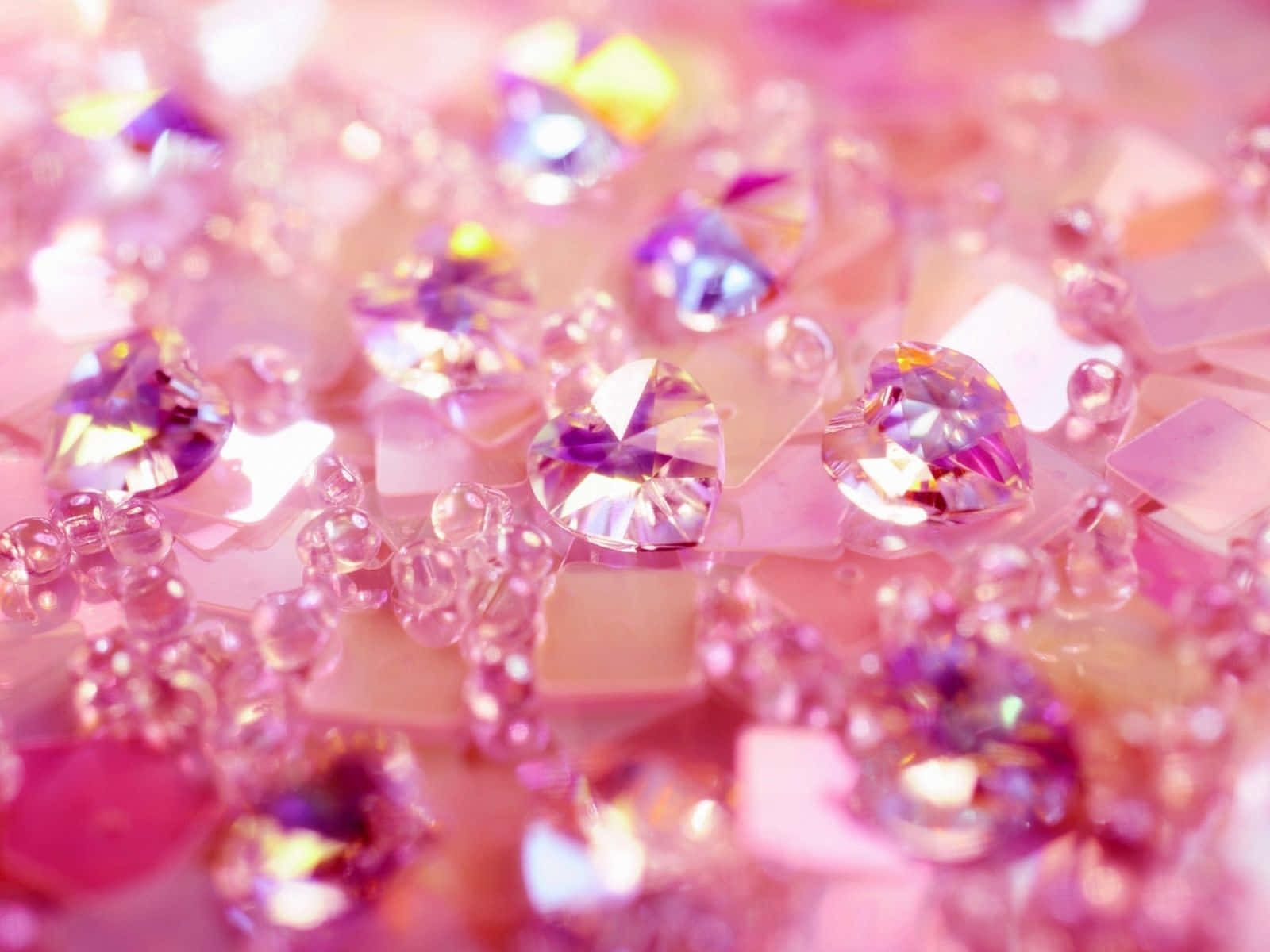 A dazzling pink diamond glistening against a light grey background.
