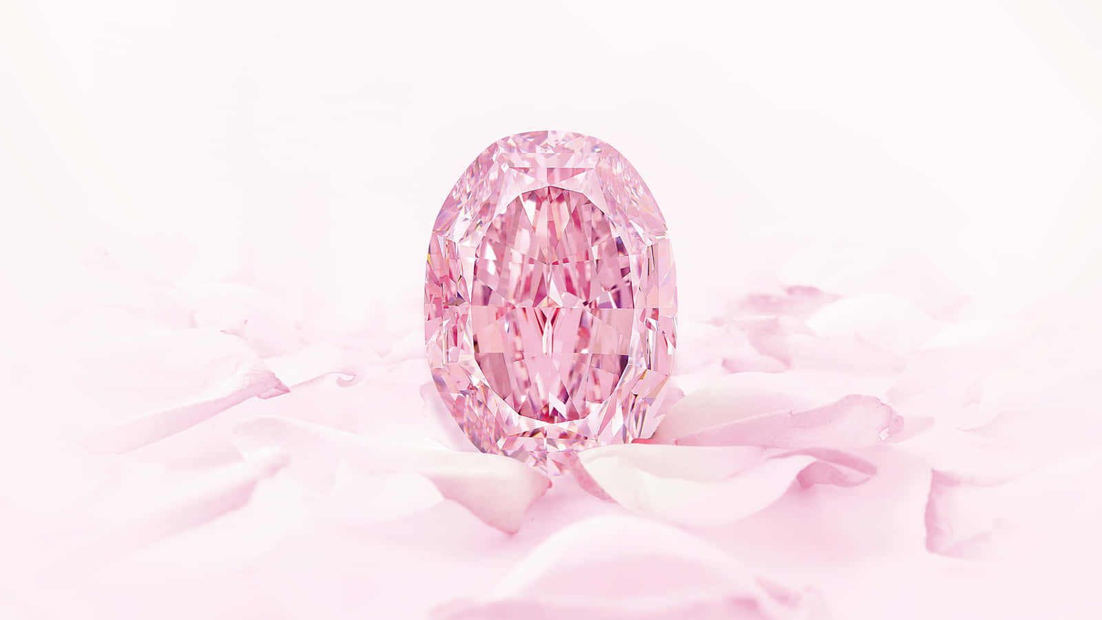 A brilliant pink diamond against a blue background.