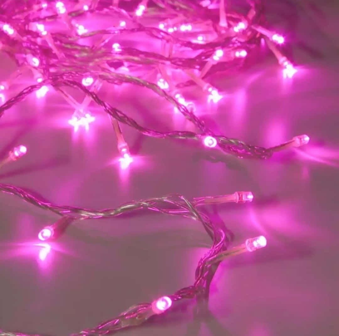 Pink Led String Lights On A Table Wallpaper
