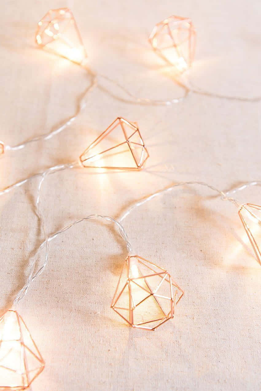 A Set Of Copper Wire Lights With Diamonds On Them Wallpaper