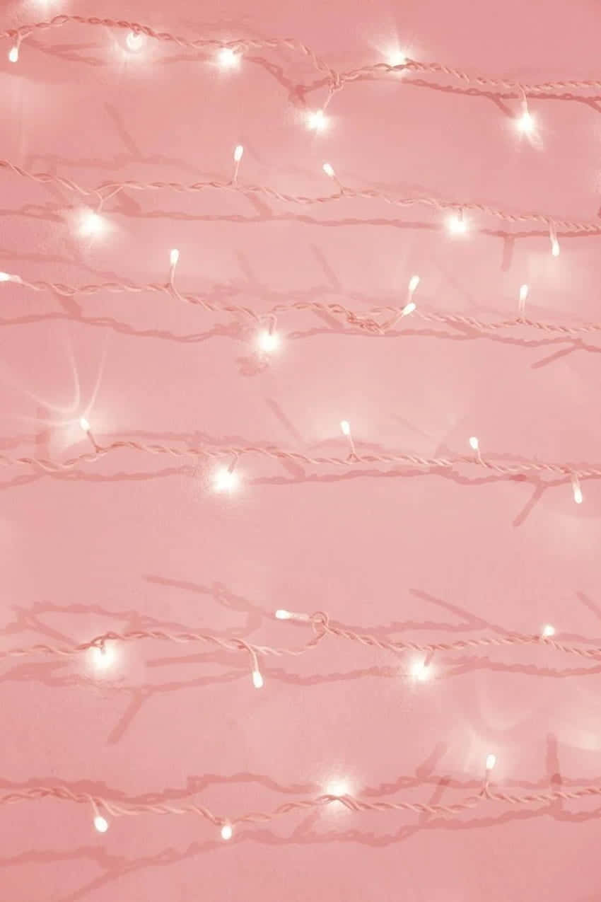 A Pink Background With White String Lights Wallpaper