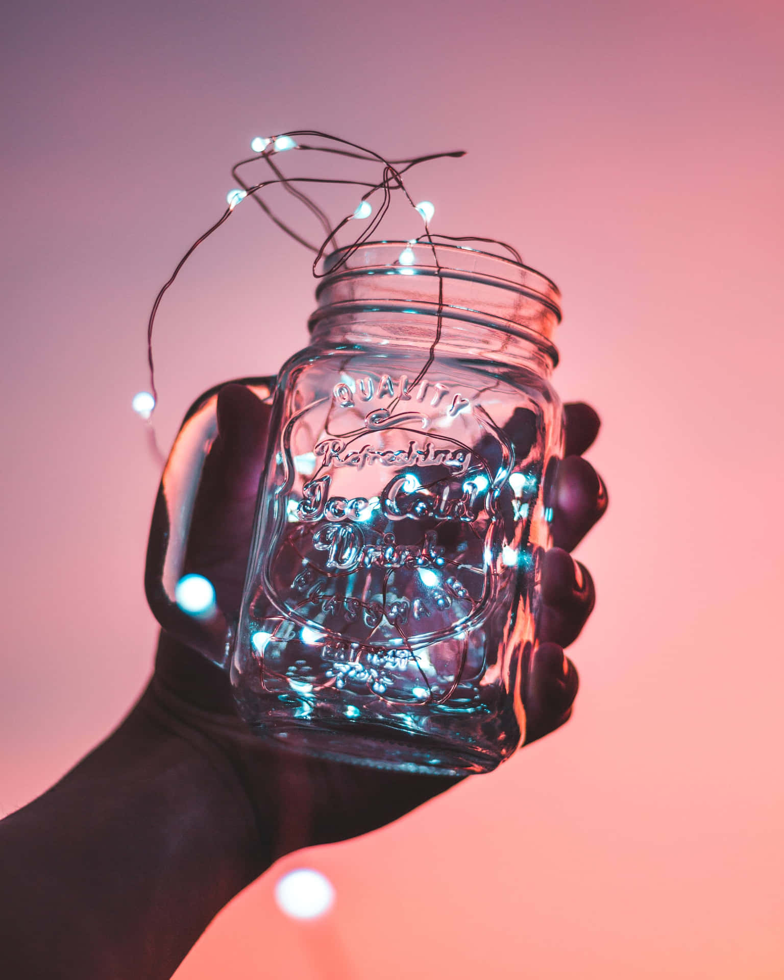 A Person Holding A Jar Of Lights Wallpaper