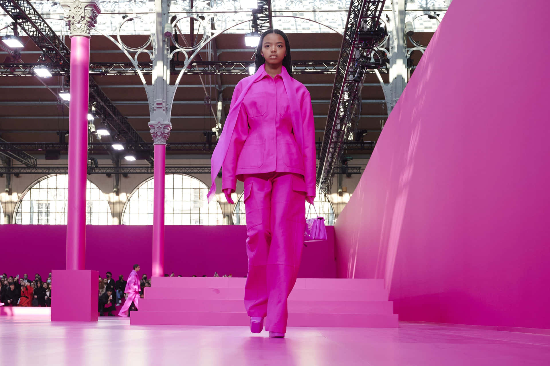 Showcasing an alluring pink ensemble in an elegant fashion photoshoot Wallpaper
