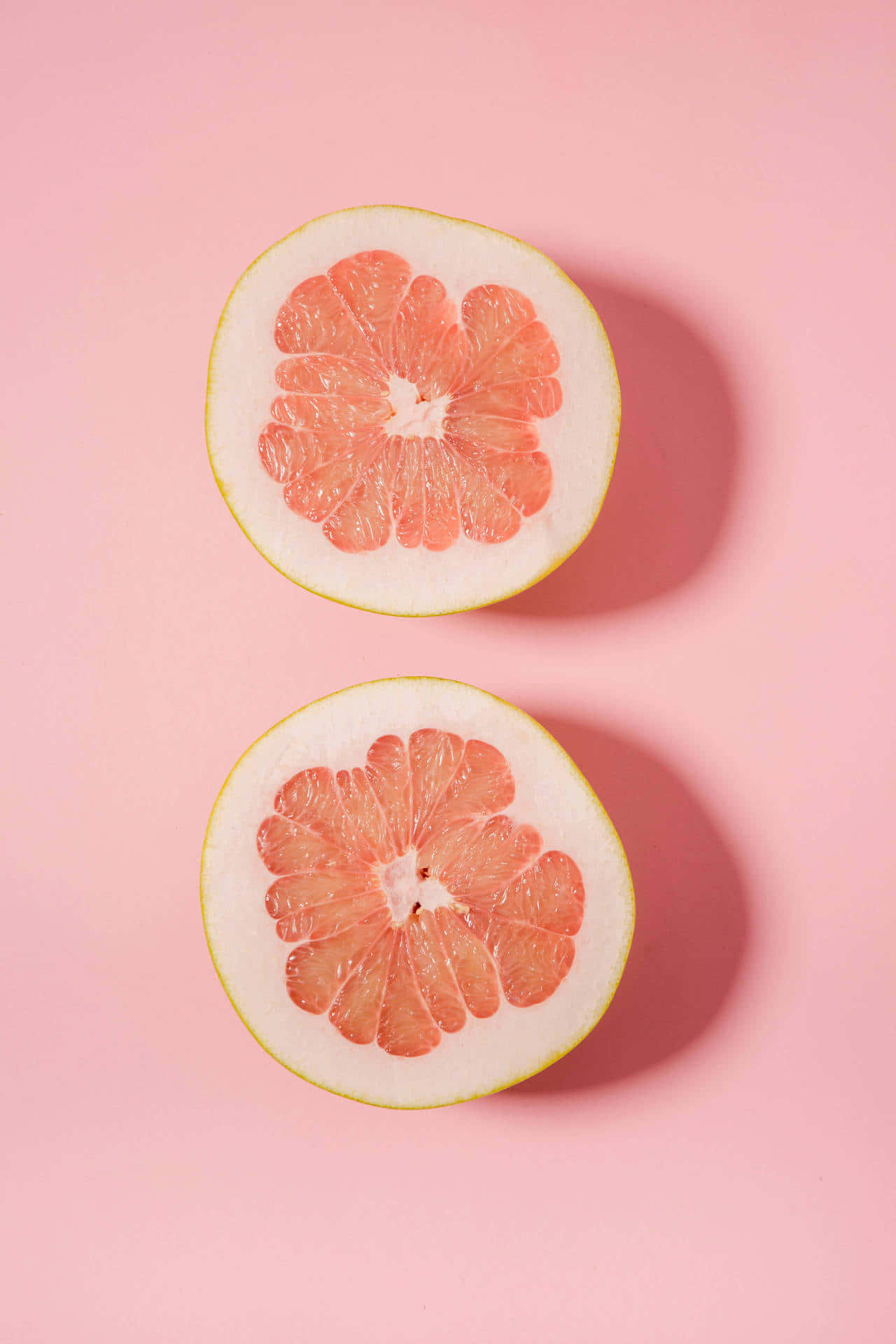 A slice of fresh pink grapefruit Wallpaper