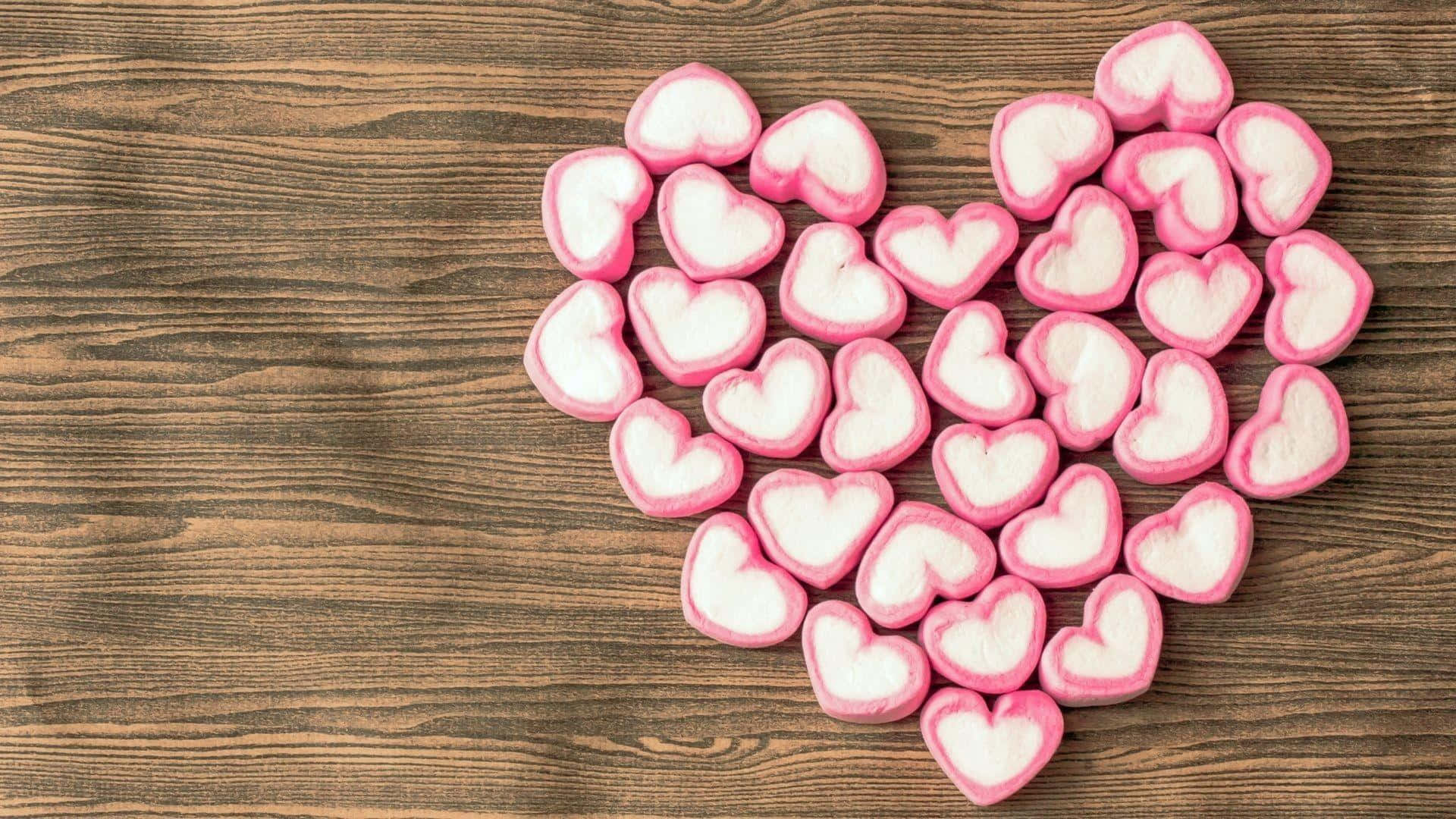 Pink Heart Candies Wooden Background.jpg Wallpaper