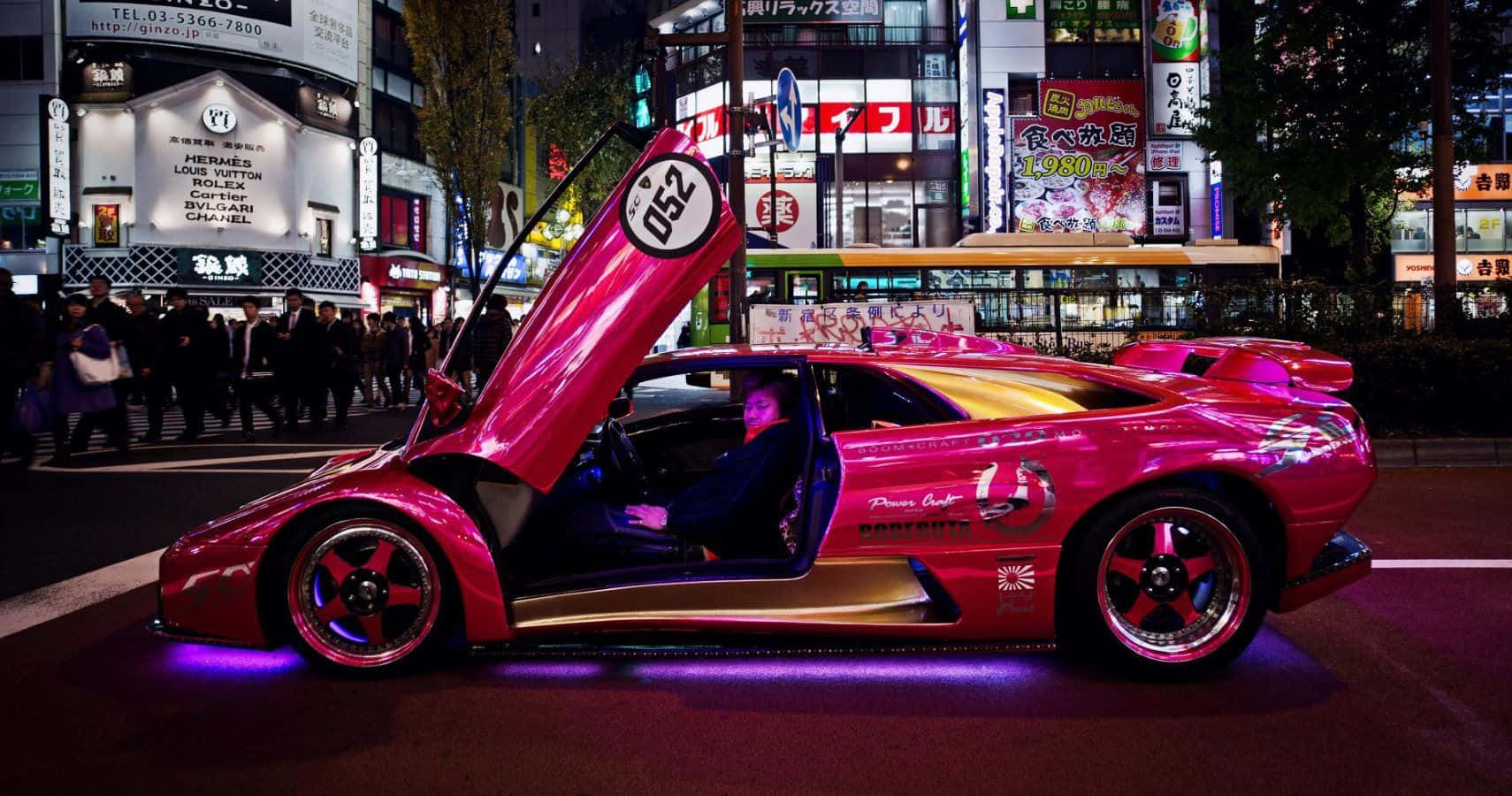 Pink Lamborghini Urban Nightlife Wallpaper