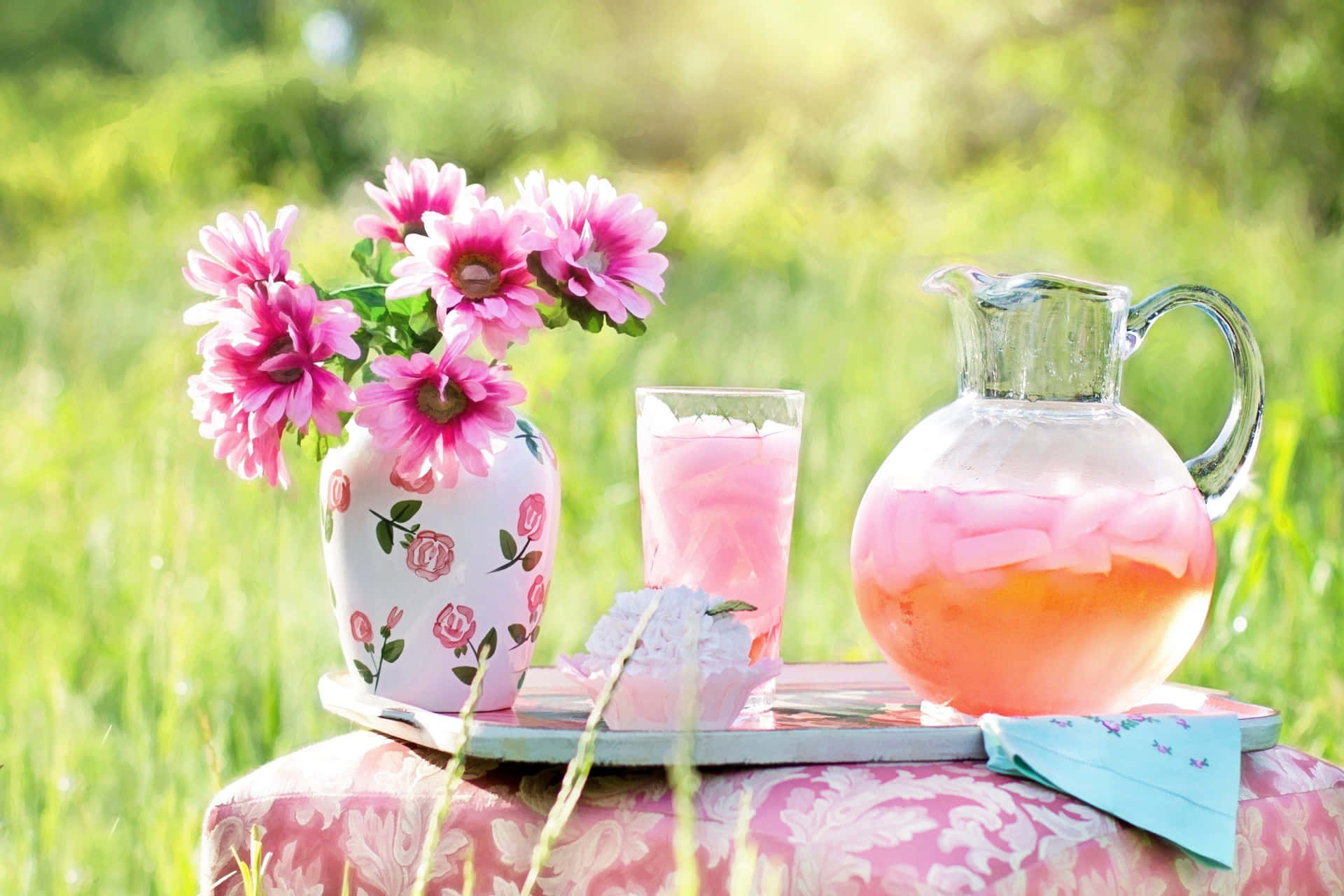 Refreshing Pink Lemonade in a Mason Jar with Ice and Lemon Slices Wallpaper