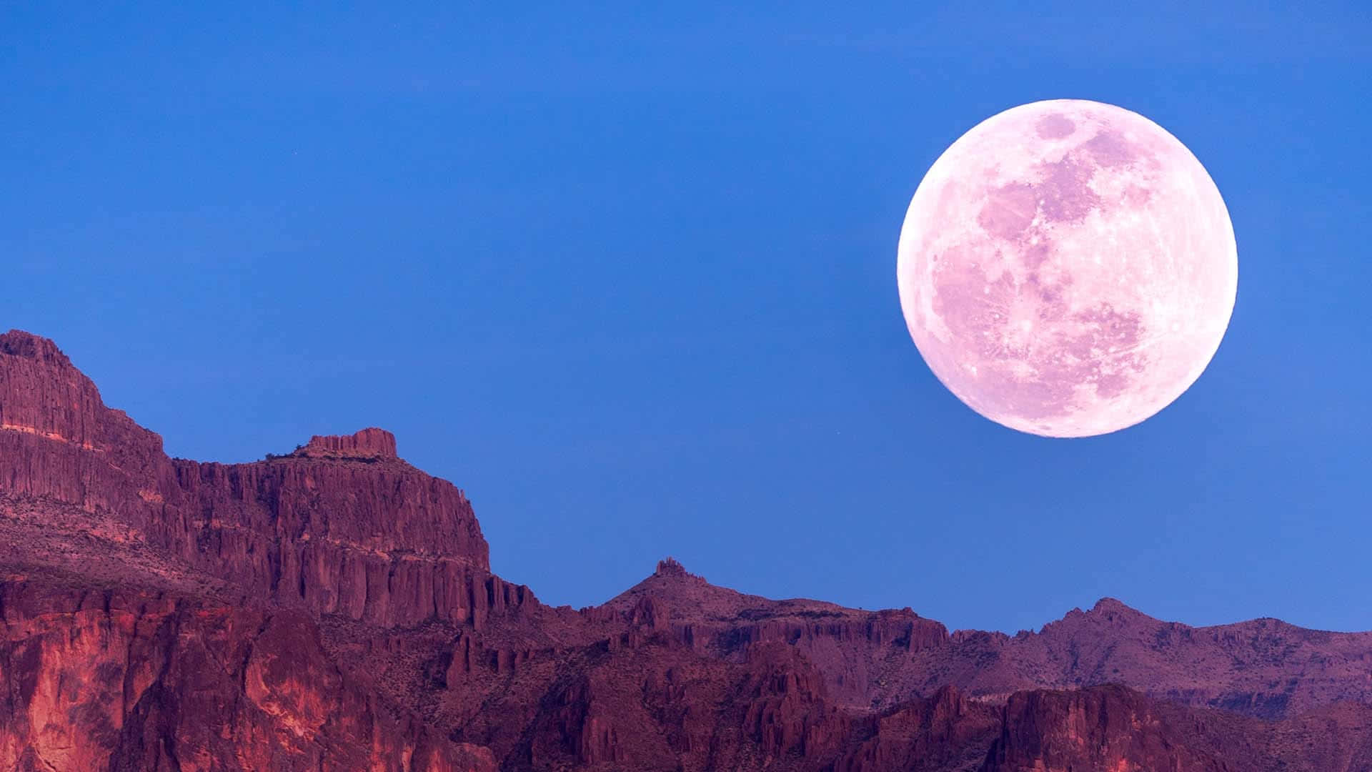 See the beautiful pink hue of the night sky with the Pink Moon overlooking