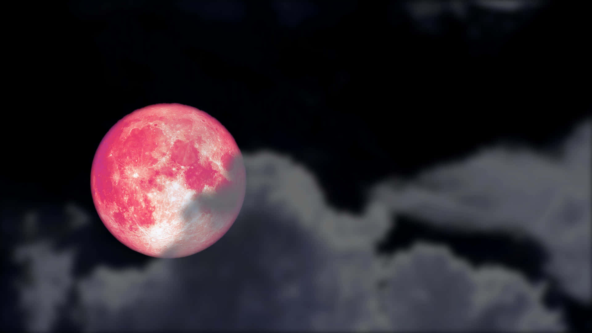 A breathtaking shot of a pink moon rising in the night sky