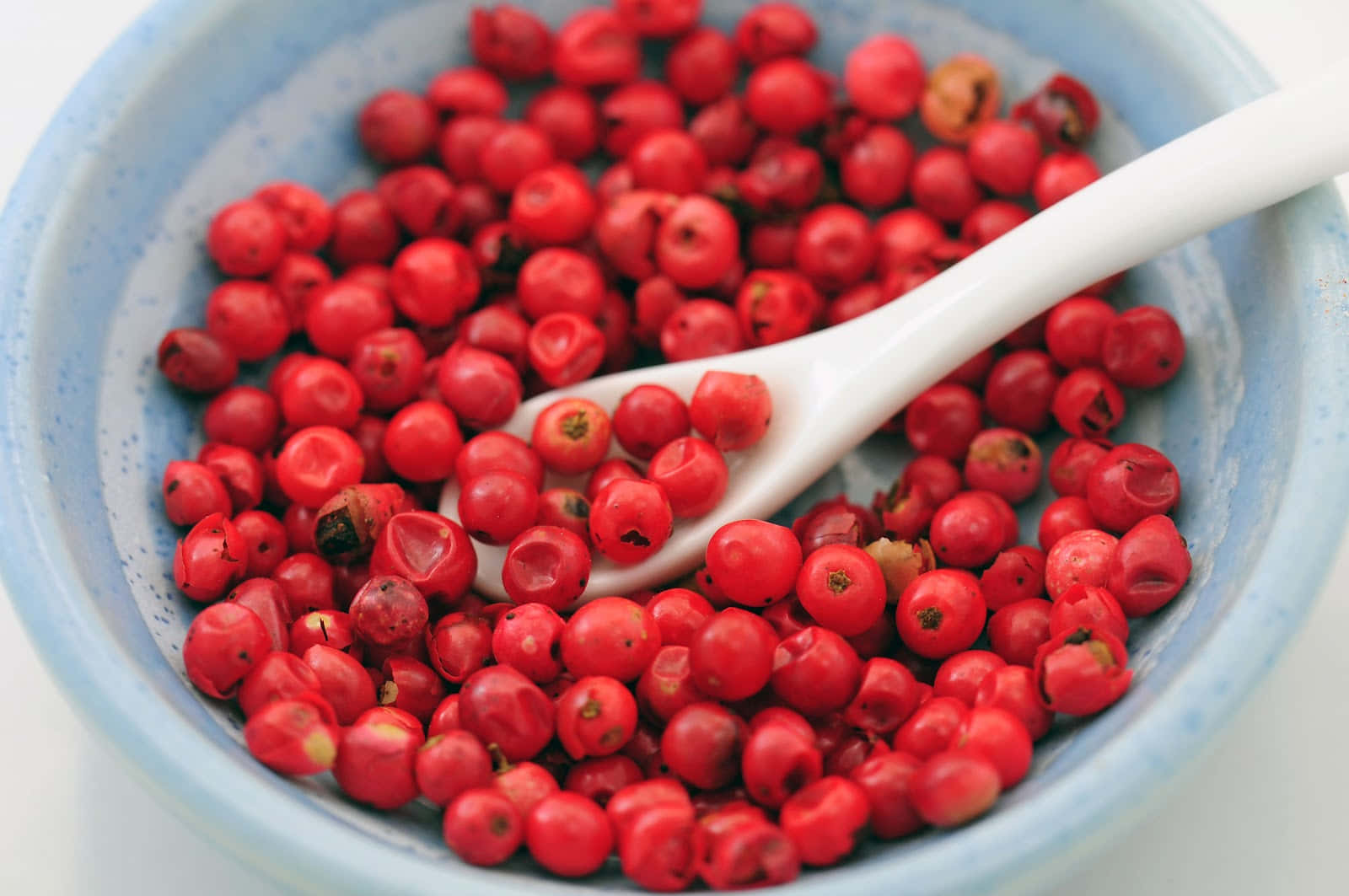 Pink Peppercorns on a Wooden Spoon Wallpaper