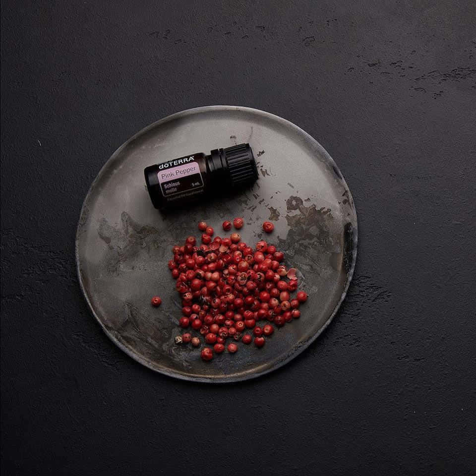 A close-up view of beautiful Pink Peppercorns on a wooden surface. Wallpaper