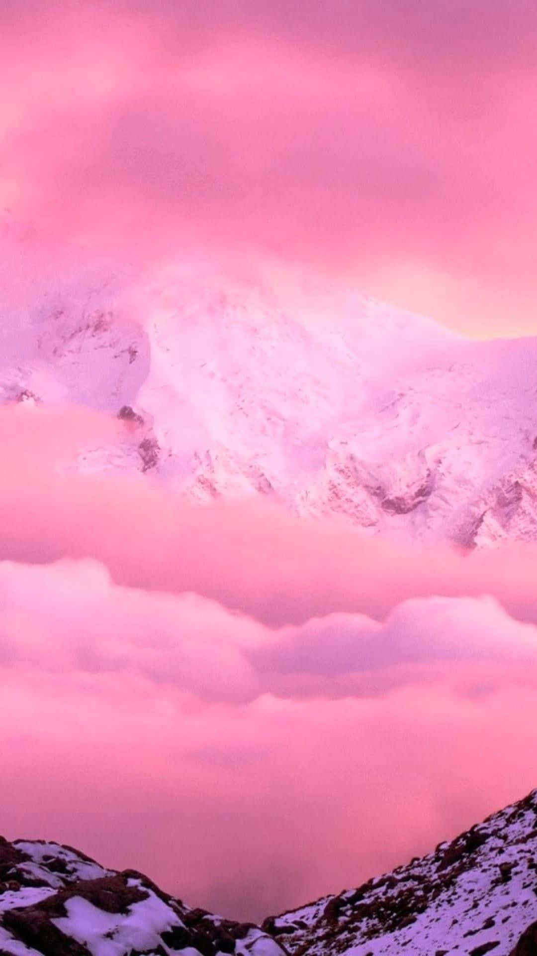 A Pink Sky With Snow Capped Mountains