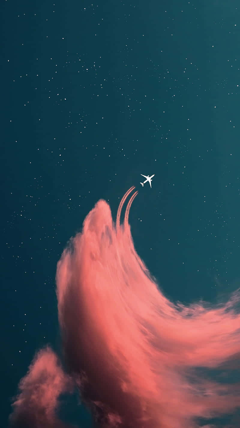 Flygöver Molnen Med Den Fantastiska Rosa Planeten. Wallpaper
