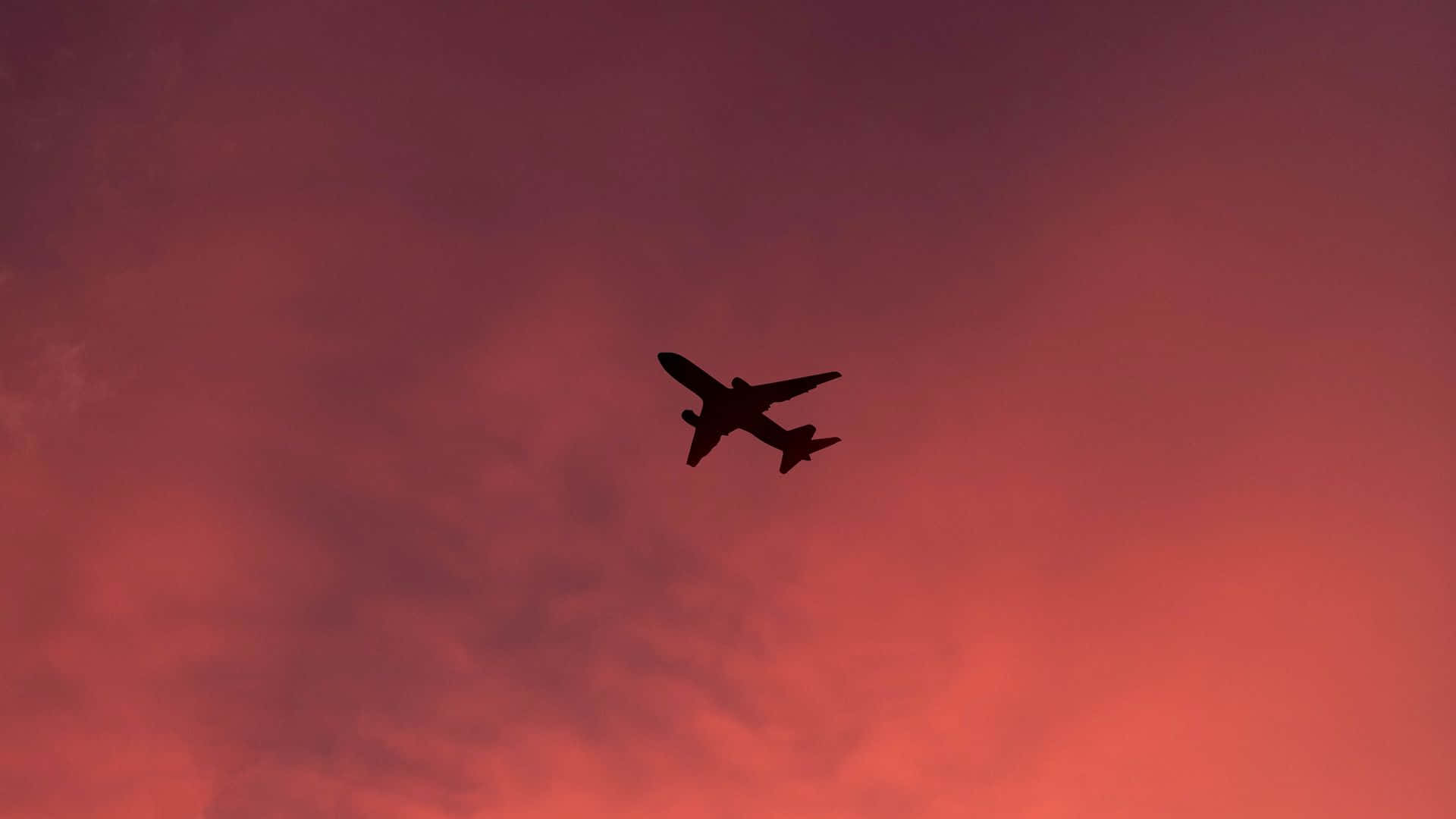 Oplev Skønheden af ​​Flight i et Smukt Pink Plane Wallpaper