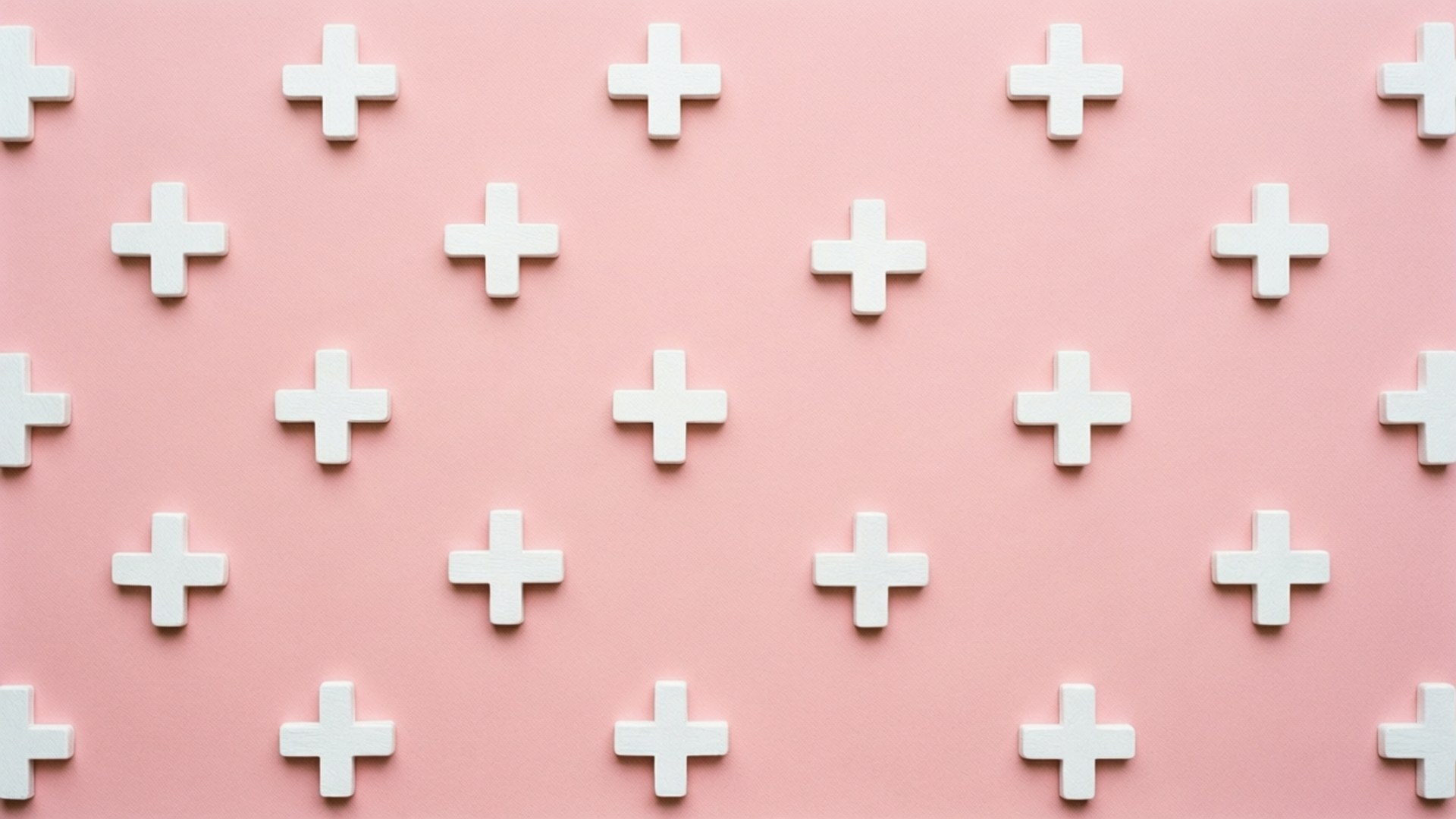 Minimalistisk tapet med vita plustecken på rosa bakgrund.