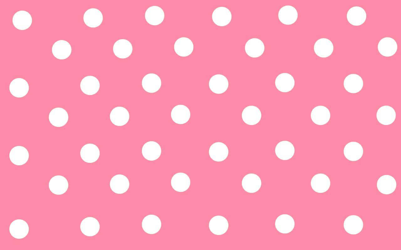 A pastel pink polka dot background