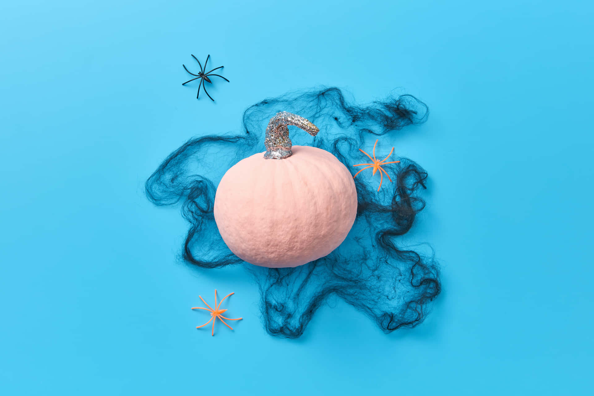 "A Vibrant Pink Pumpkin Against a Vibrant Orange Autumn Leaves" Wallpaper