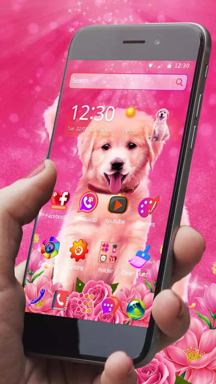 Eineperson Hält Ein Pinkes Telefon Mit Einem Welpen Darauf. Wallpaper
