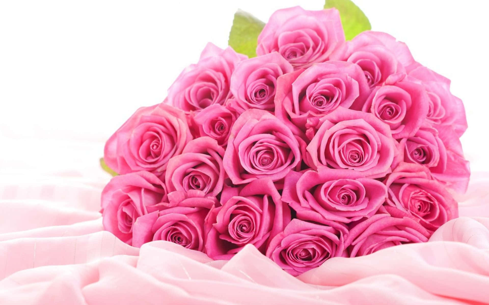 Ramode Flores Sobre Un Fondo De Tela Con Rosas Rosadas.