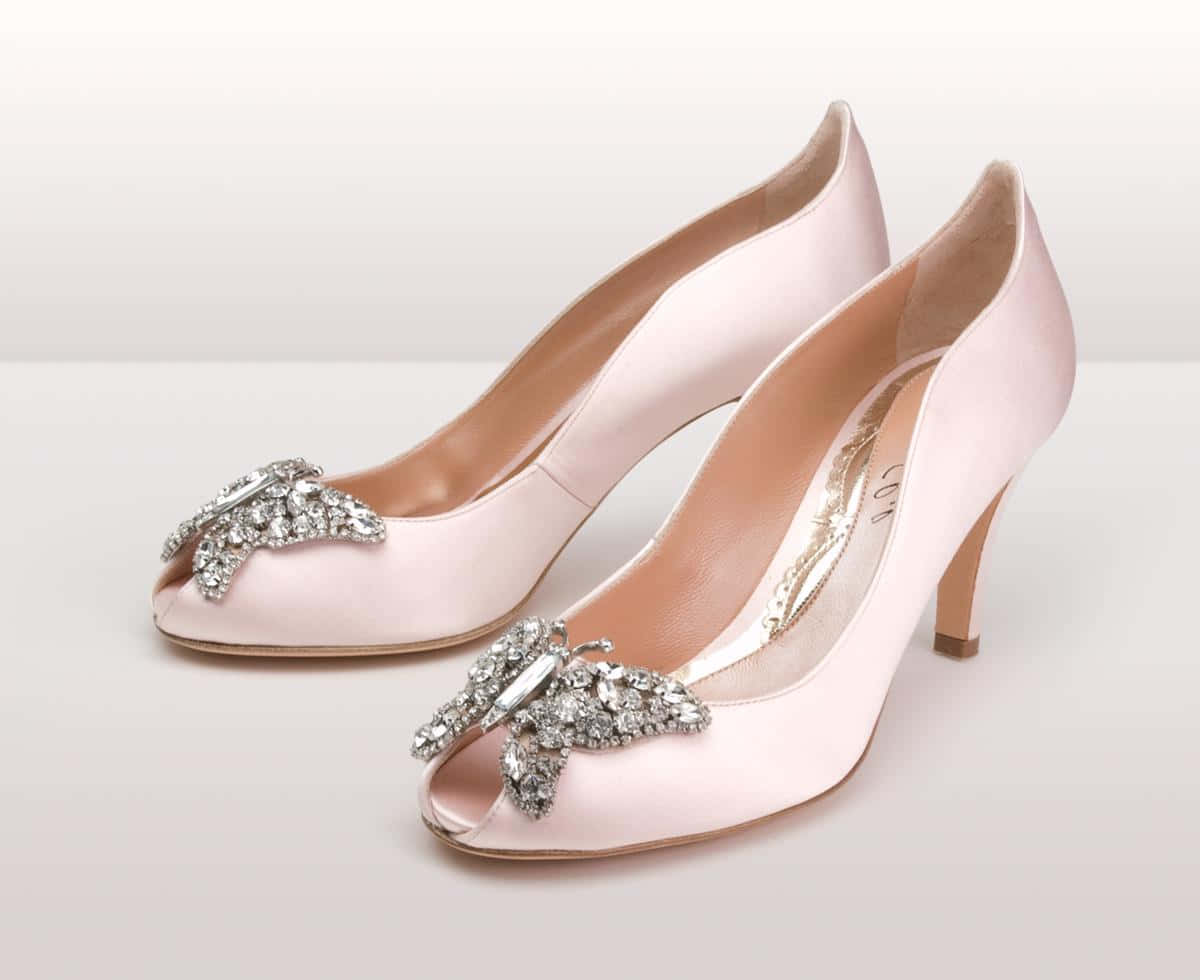 A pair of pink high heel shoes on a soft, feminine background Wallpaper