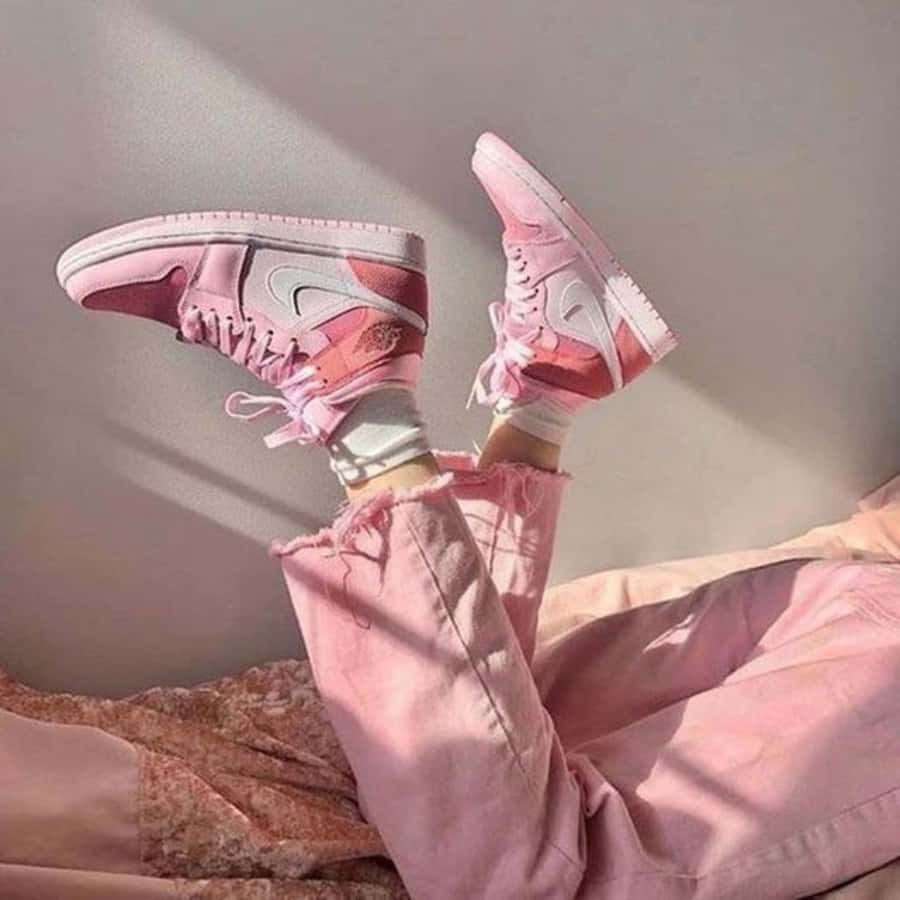 Stylish Pink Shoes on a White Surface Wallpaper