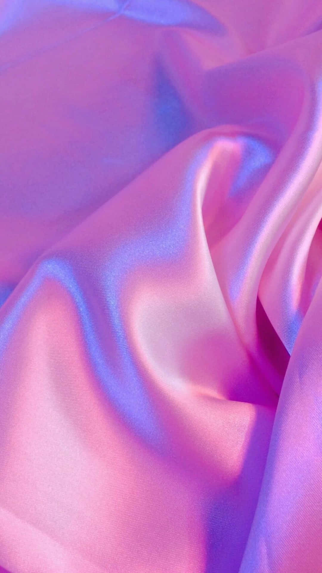 A Close Up Of A Pink And Blue Satin Fabric Wallpaper