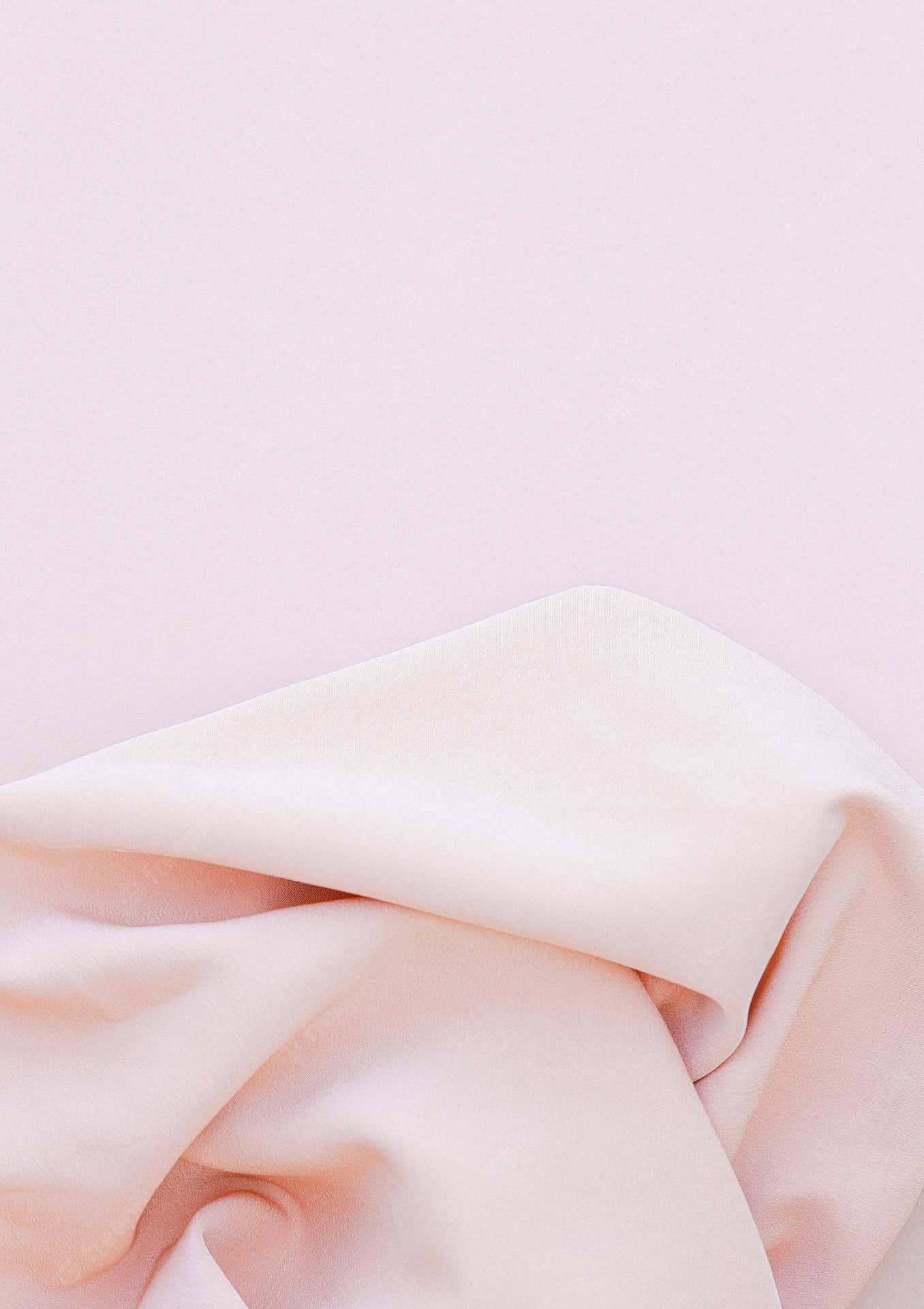 A Pink Blanket On A White Surface Wallpaper
