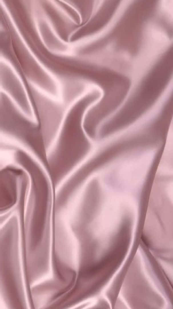 A Pink Satin Fabric With A Smooth Texture Wallpaper